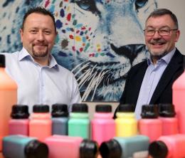 Multichem managing director Michael Nelson and EEN adviser David Boath with bottles of coloured inks in the foreground.