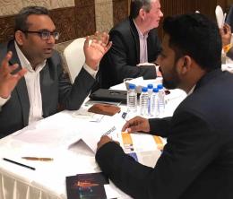 Abhishek Srivastava, Executive Director at Teknobuilt, in animated conversation sitting at a table across from a potential partner at a B2B event.