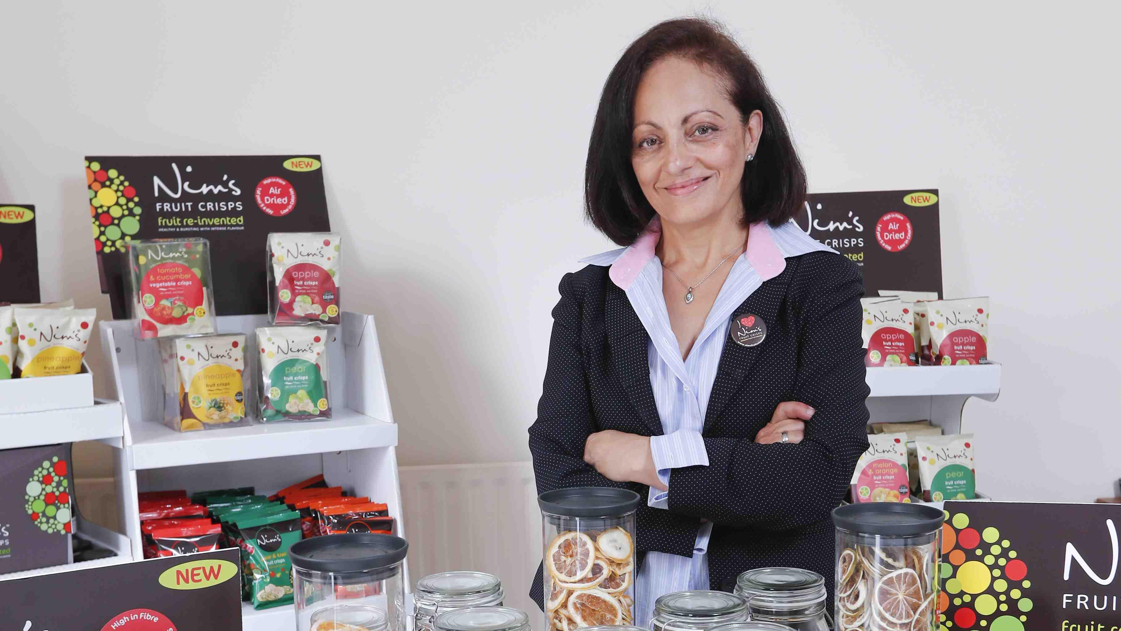 Nimisha Raja with examples of the Nim's Crisps product range