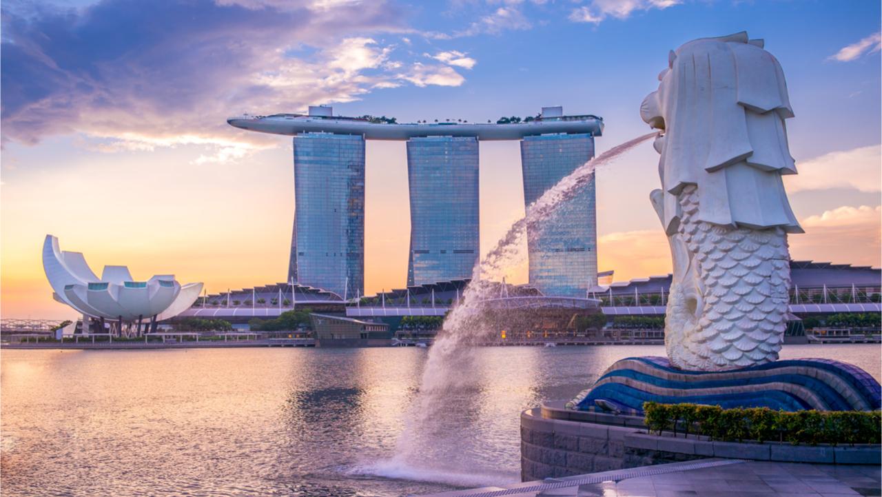 sunrise at the marina in singapore with the iconic building merlion