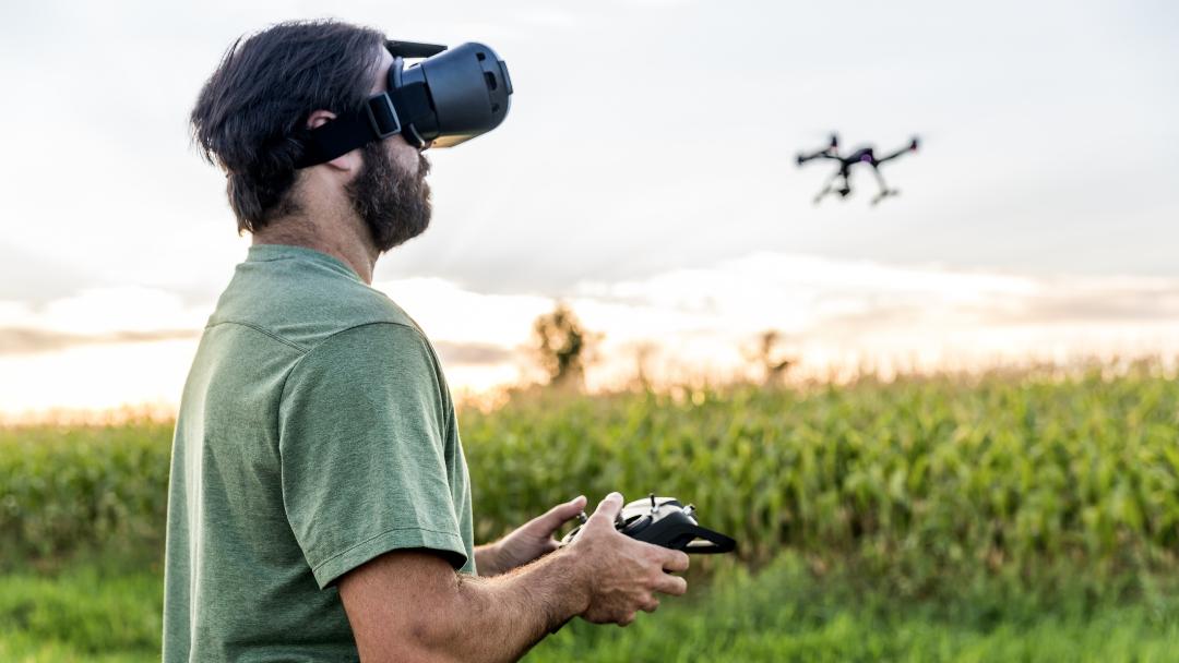 Man Flying a Drone with Virtual Reality Goggles Headset