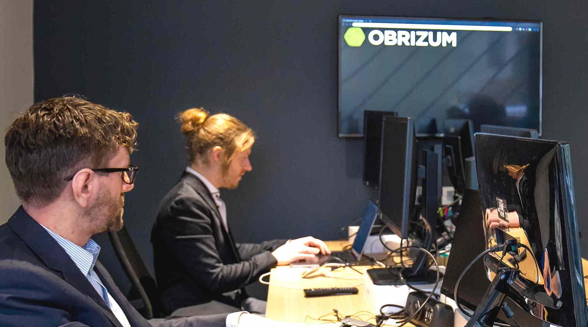 Two members of OBRIZUM's R&D team at their computers. 