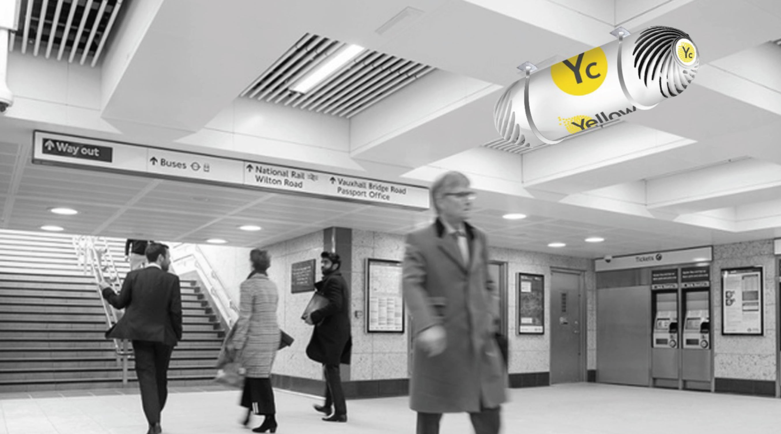 Computer generated image of Yellow Collective fan installed in railway station underground walkway, above commuters