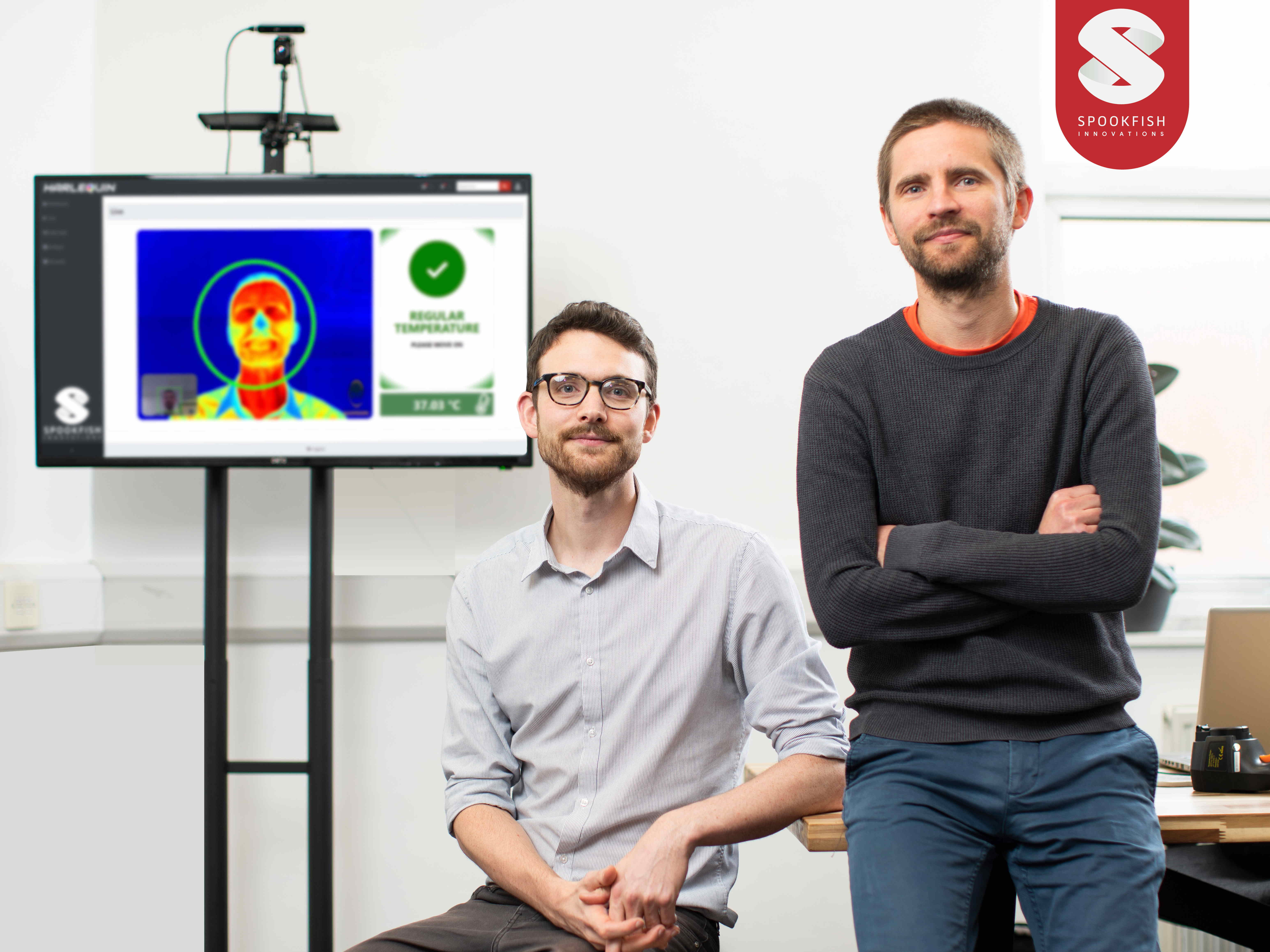Spookfish directors John Robinson and Jouni Ronkainen pictured in front of a screen displaying their fever detection technology